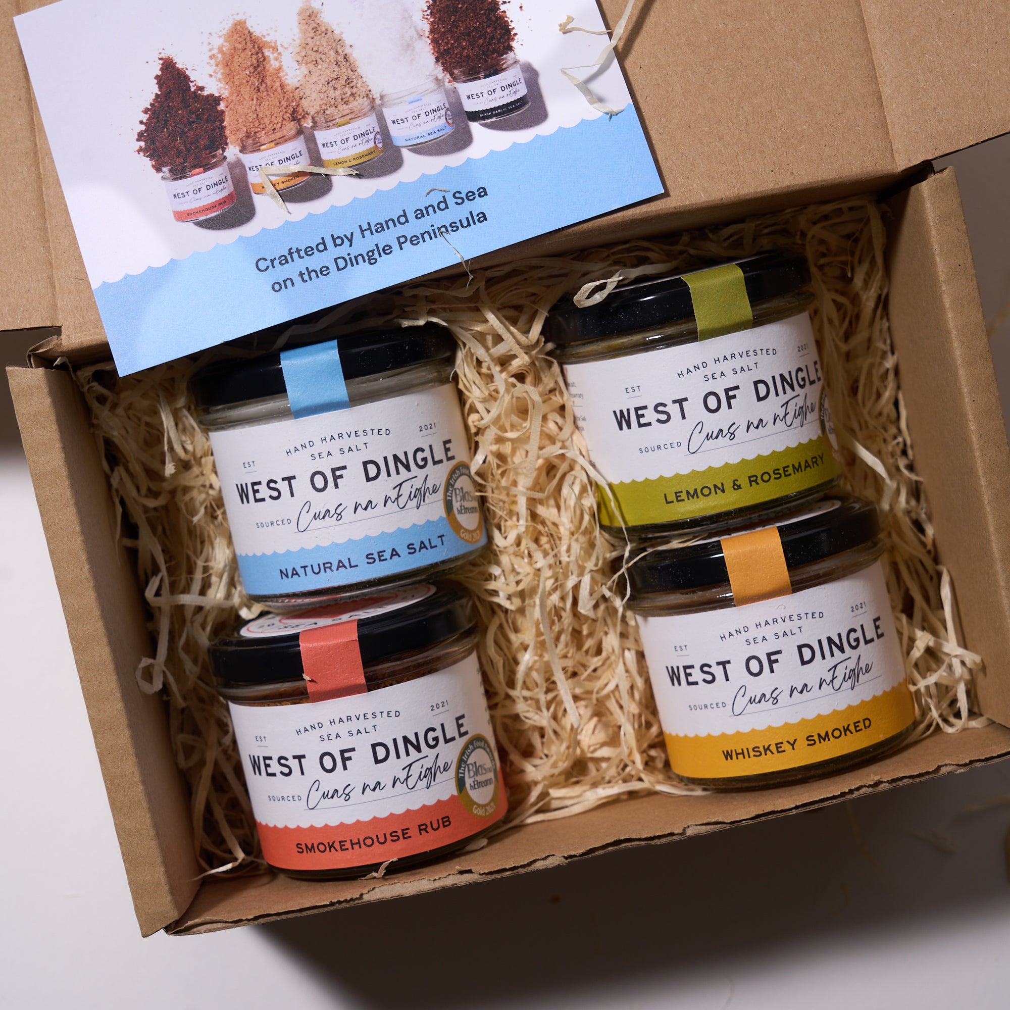 Box of West of Dingle food products with various jars and a branded card.